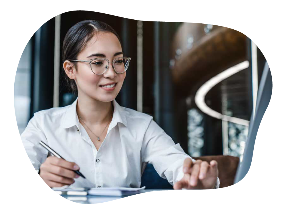 Business woman happily monitoring company's finances via laptop